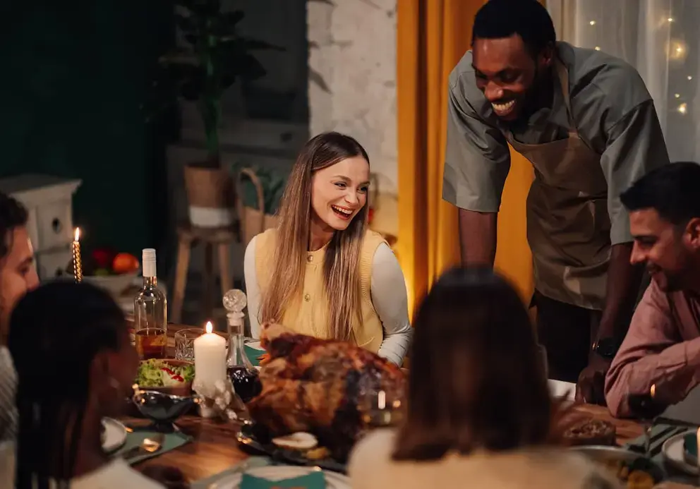 Friends at dinner table smiling