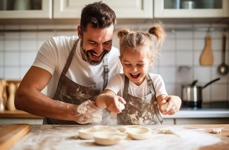 A parent with their child, cooking