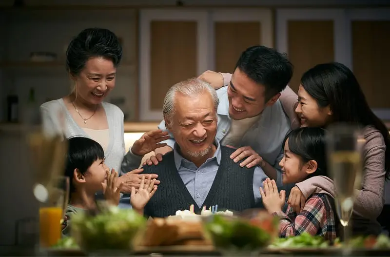 A parent with their child, cooking